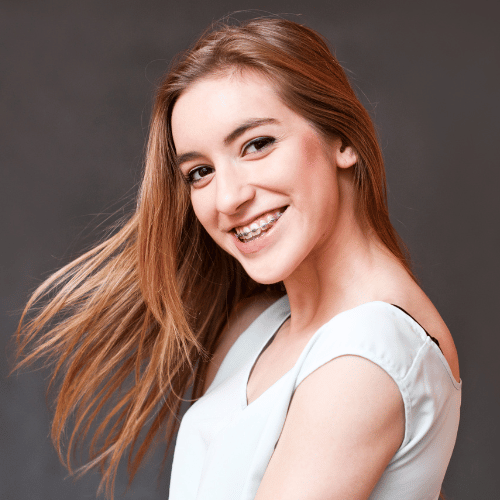 A female teenager with braces smiling